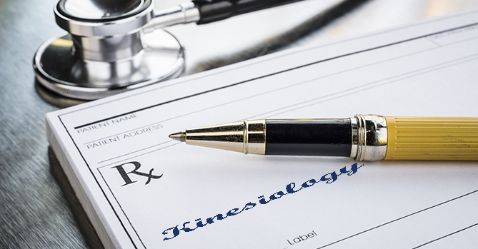 A doctor fills a prescription pad for a patient to see a Kinesiologist.