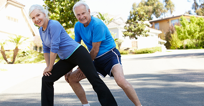 Elderly Couple Stretching Together